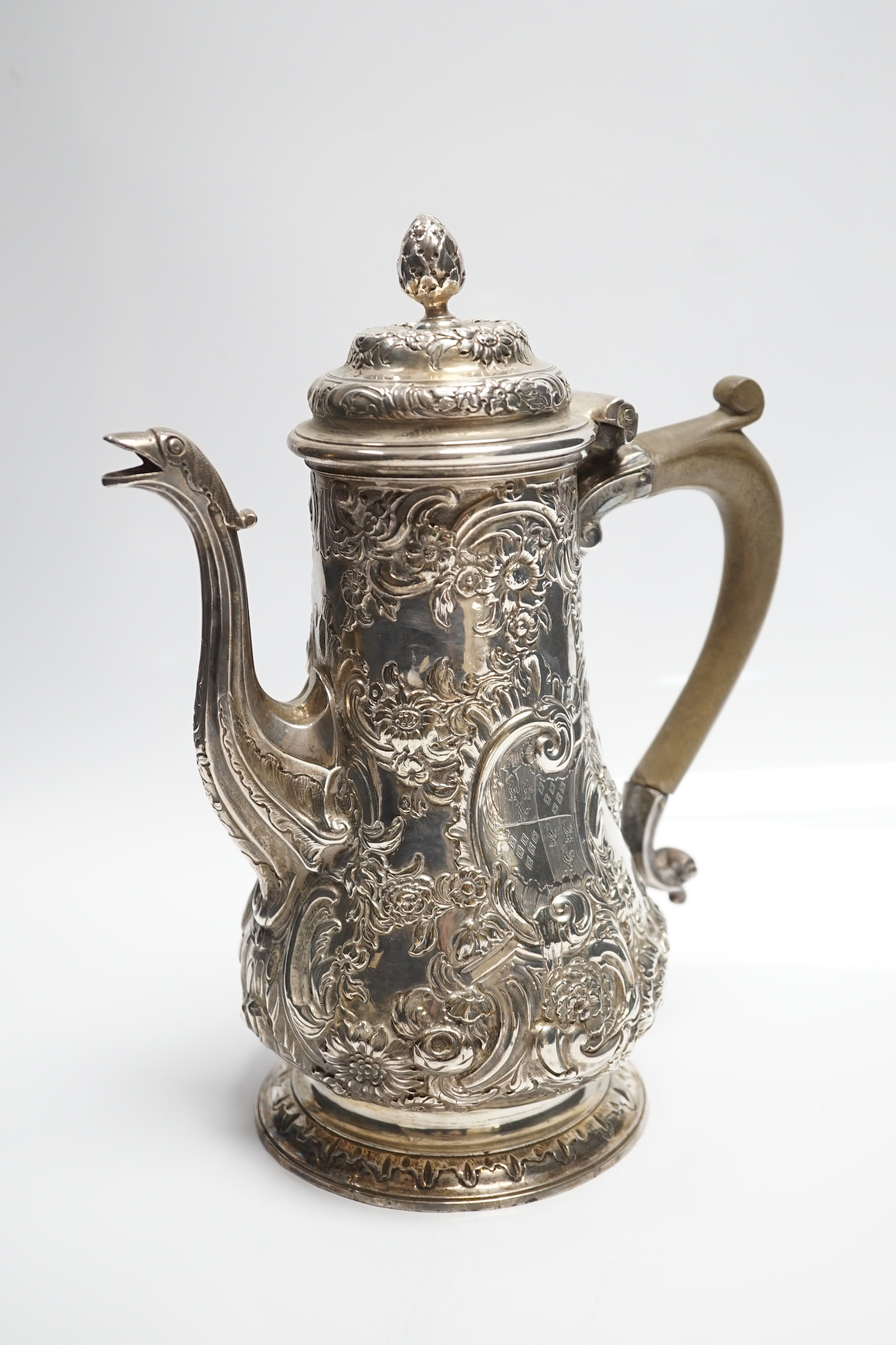 A George II silver baluster coffee pot, with later embossed decoration, maker, ?W, London, 1751, height 25.5cm, gross weight 31.3oz.